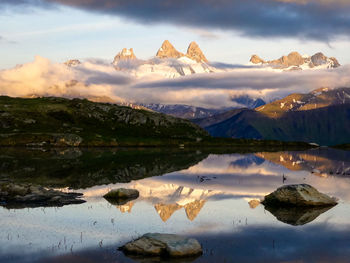 Scenic view of lake and mountains against sky