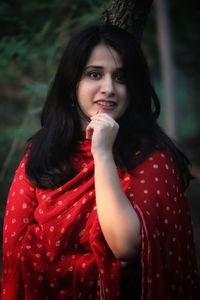 Portrait of beautiful young woman standing outdoors