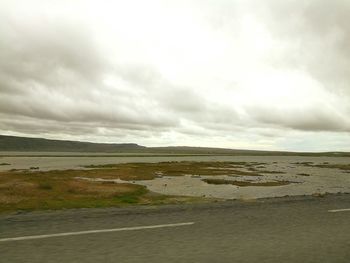 Scenic view of sea against cloudy sky