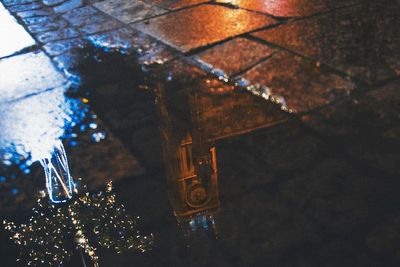 High angle view of illuminated wet glass