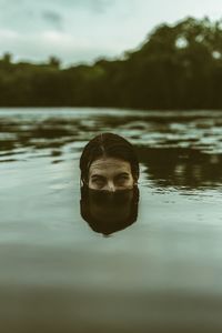 Portrait of man swimming in pool