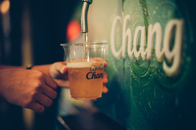 Close-up of hand holding drink