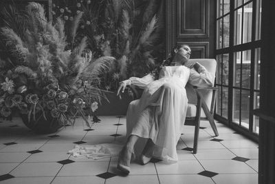 Woman sitting on seat at home