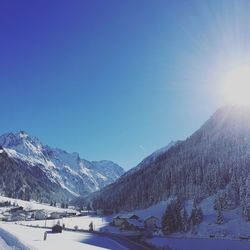 Scenic view of snowcapped mountains against clear blue sky