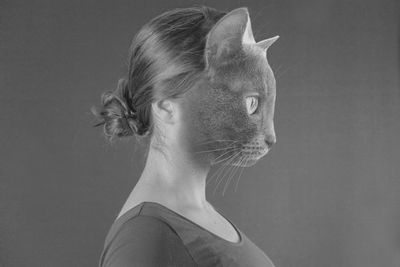 Digital composite image of cat and woman against gray background