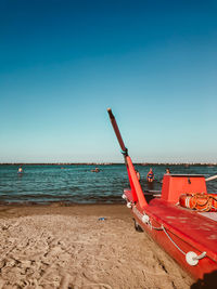 Scenic view of beach against clear blue sky