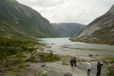 People on mountain against sky