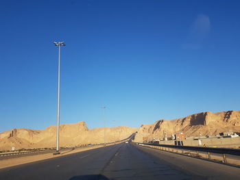 Highway against clear blue sky