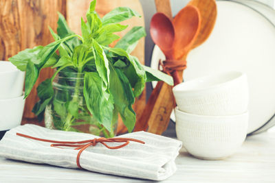 Close-up of herbs and utensils with napkin on table