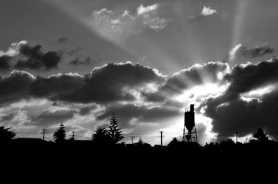 Low angle view of silhouette trees against sky