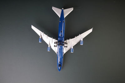Directly above shot of toy airplane on black background