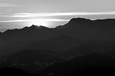 Scenic view of silhouette mountains against sky at dusk