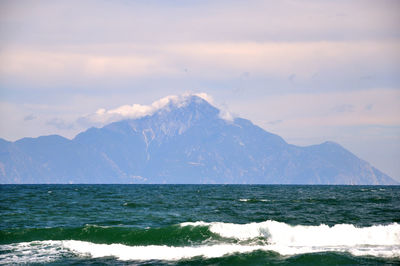 Scenic view of sea and mountains against sky