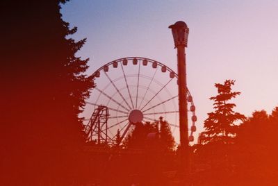 Low angle view of ferris wheel against clear sky