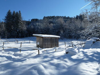 Snow on field against sky during winter