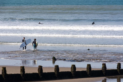 People surfing in sea