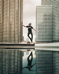 Man jumping at office building