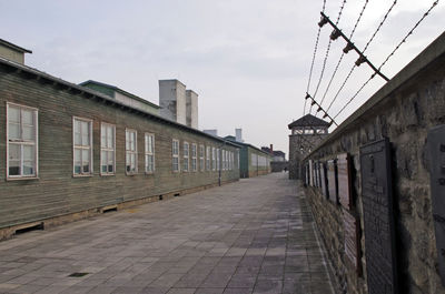 Empty alley amidst buildings in city