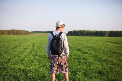 Rear view of man standing on field
