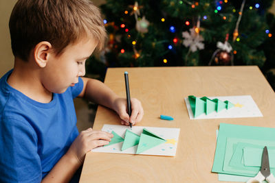 Boy drawing on paper