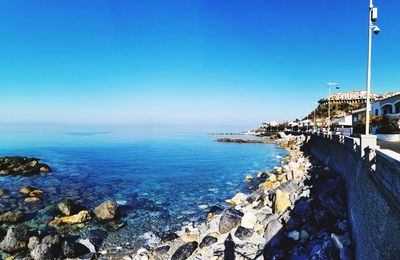 Scenic view of sea against clear blue sky