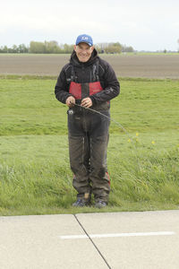 Full length of young woman standing on grass