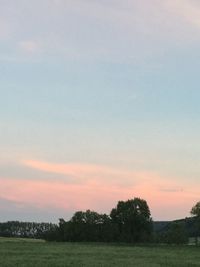 Scenic view of field against sky during sunset