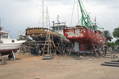 Fishing boats, wooden boats and ships on the lift in a shipyard in bodrum, turkey