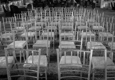 Stack of empty chairs in building