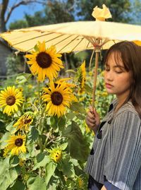 Low angle view of woman by sunflower