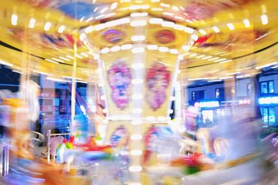 Low angle view of illuminated ferris wheel at night