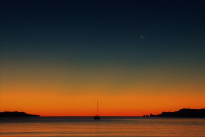 Scenic view of sea against orange sky