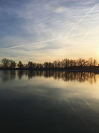 Scenic view of calm lake against cloudy sky