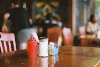 Glass of bottles on table in restaurant