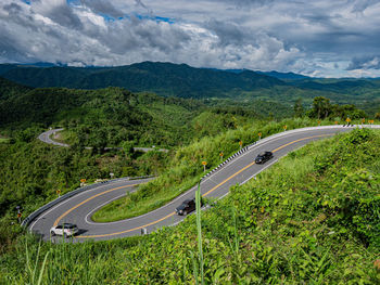 High angle view of road by mountains against sky