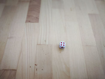 High angle view of dice on hardwood floor at home