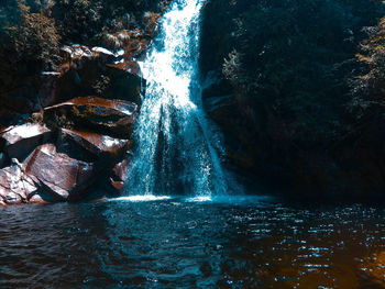 Water flowing through rocks in forest