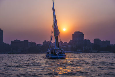 Boat in sea at sunset