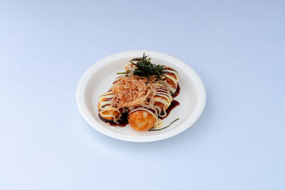 High angle view of food in plate on white background