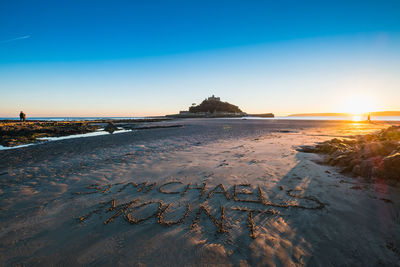 Scenic view of beach against clear sky