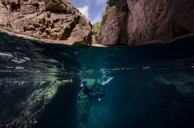 Low angle view of people swimming in sea