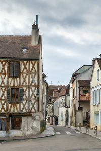 Street amidst buildings against sky