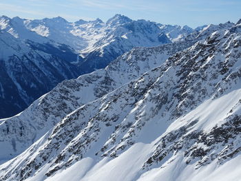 Scenic view of snow covered mountains against sky