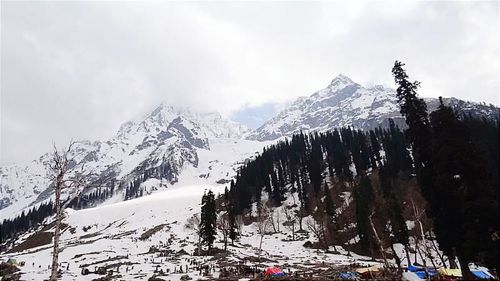 Scenic view of snow covered mountains against sky