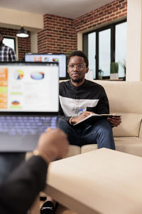 Portrait of man using laptop at home