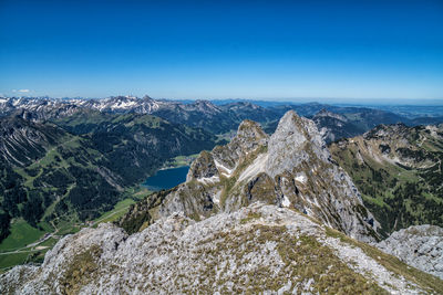 Scenic view of mountains against clear blue sky