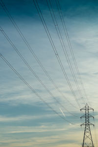 Low angle view of electricity pylon against sky