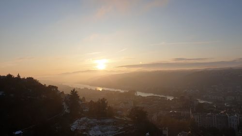 Scenic view of sunset over city