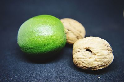 Close-up of fruits on table against black background