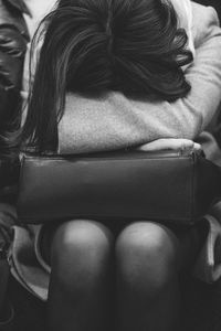 Rear view of woman sitting on sofa at home